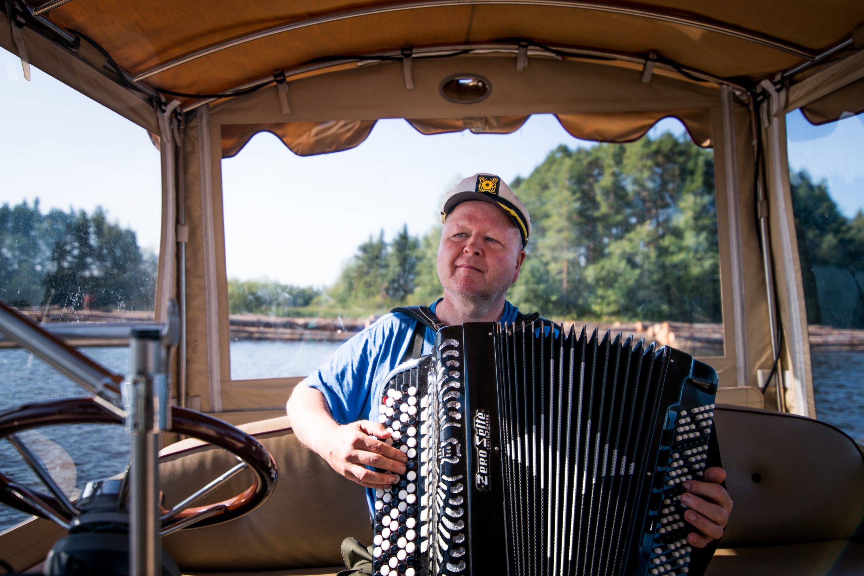 A man playing accordion in boat