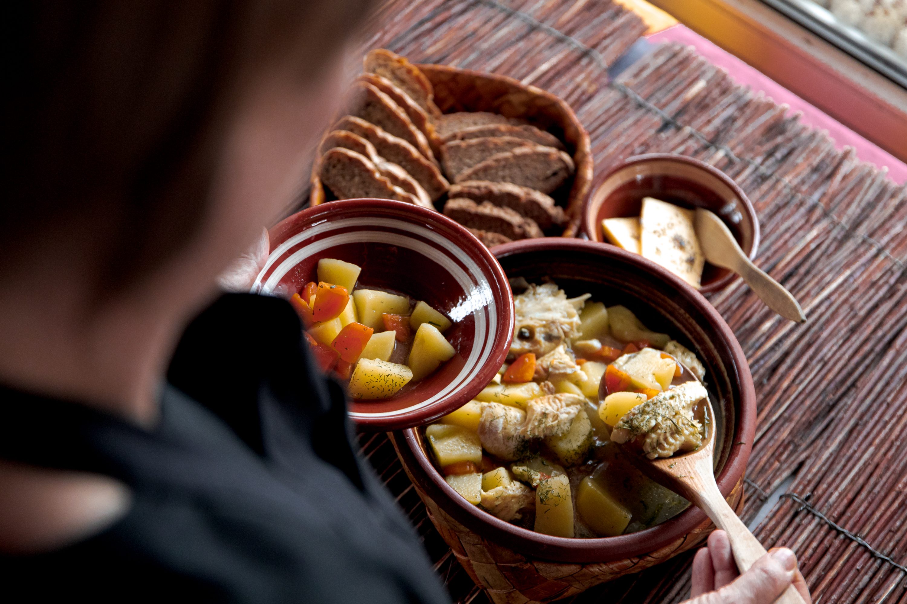 A woman taking fish soup