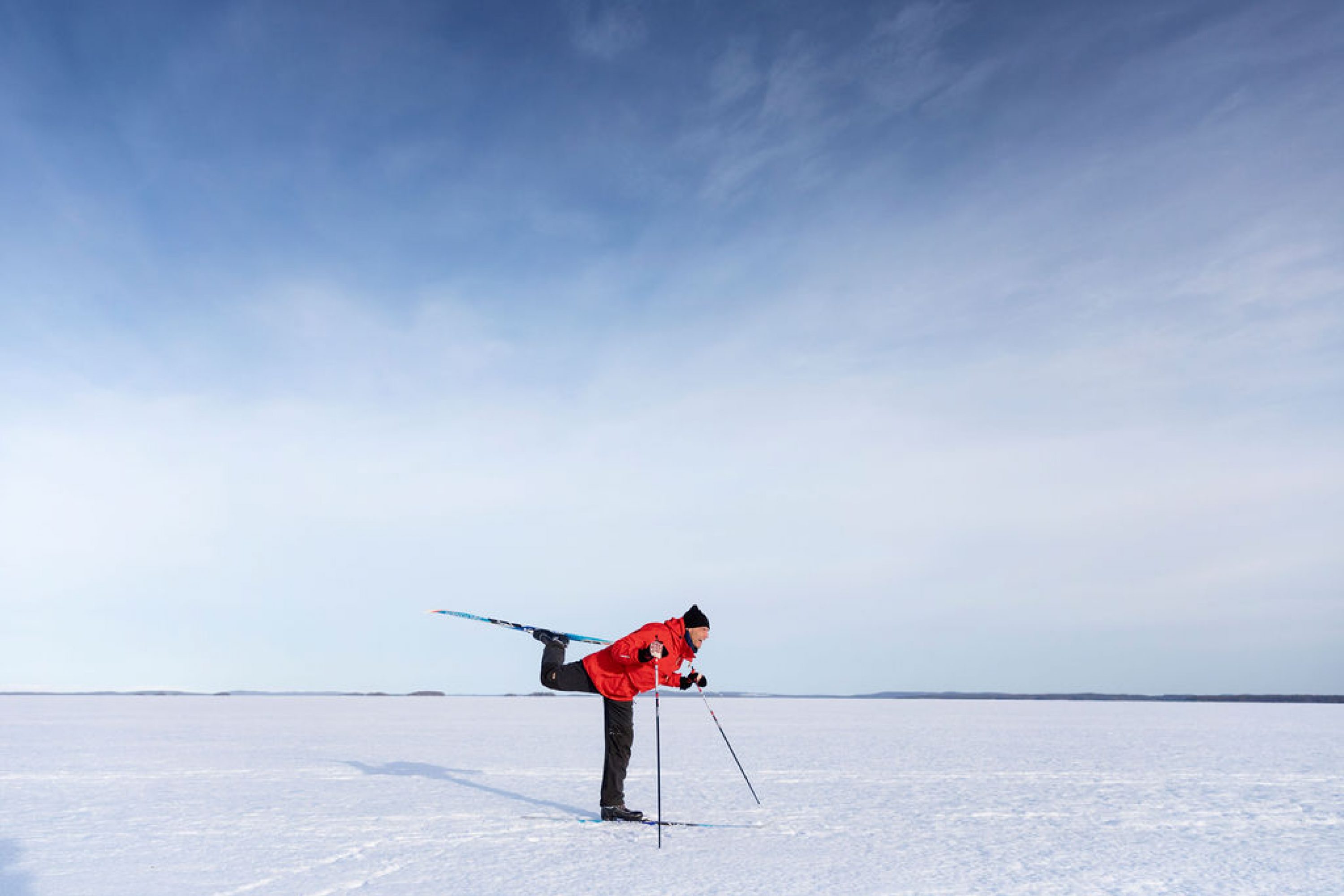 A man skiing on the frozen lake