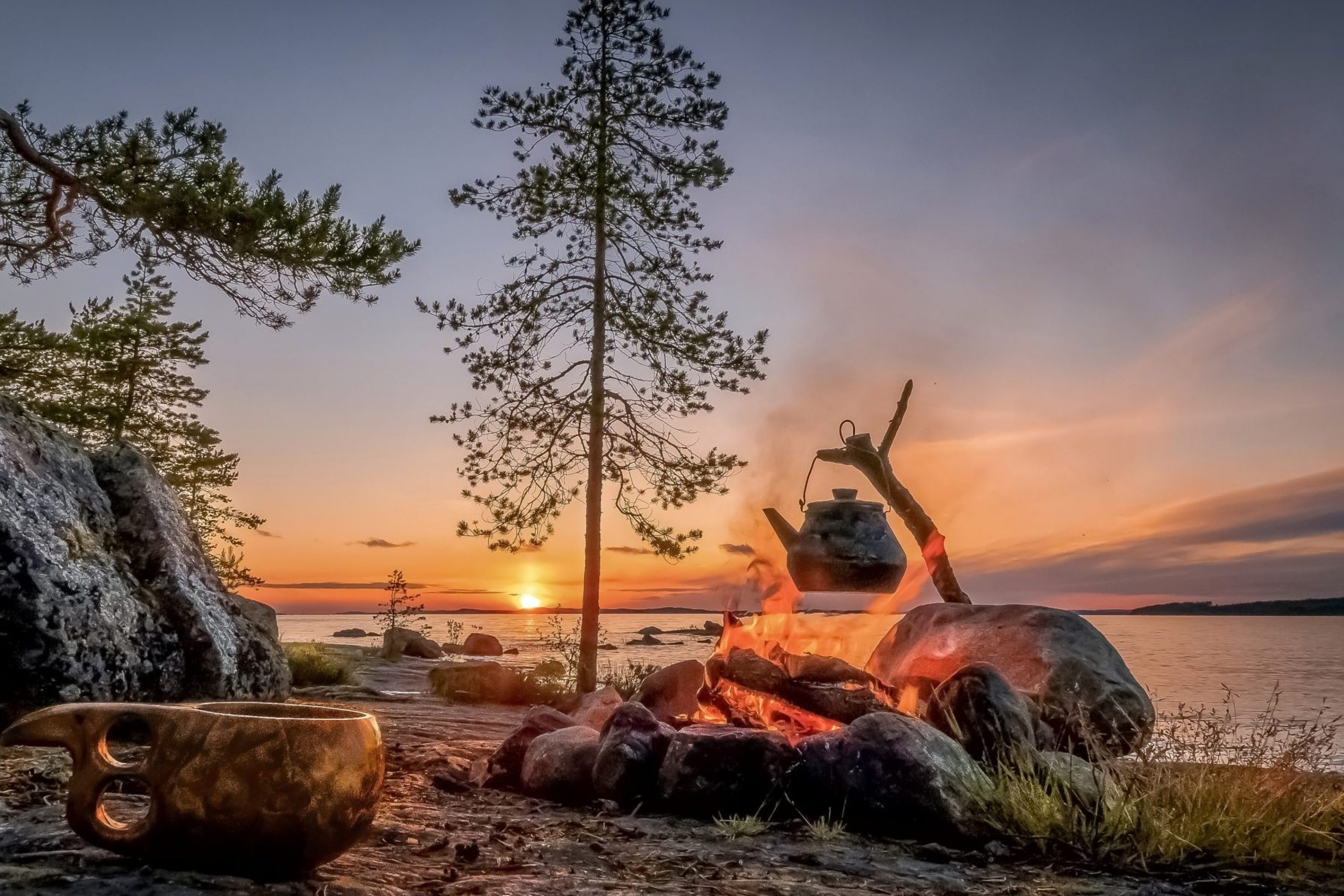 Preparing coffee by the open fire during the sunset