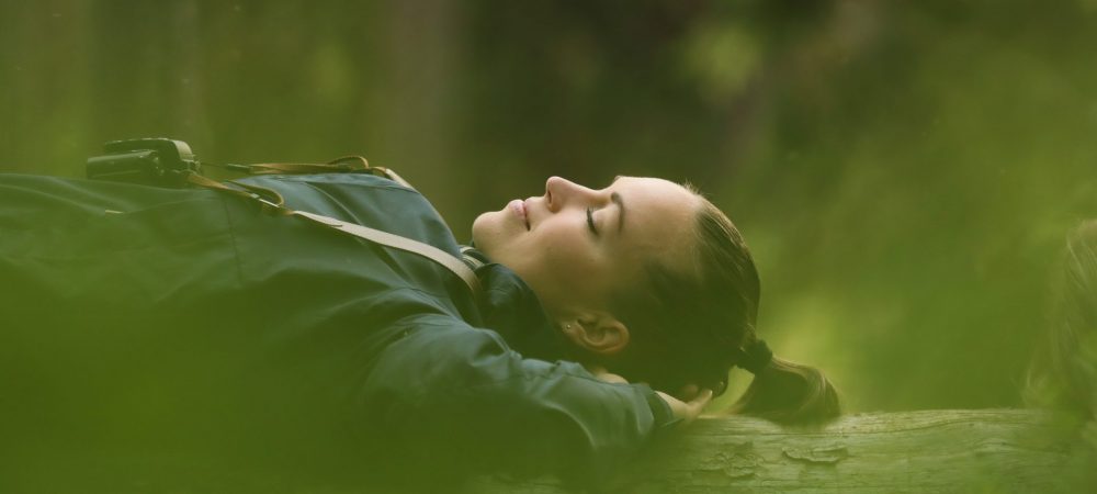 A woman lying on the fallen tree