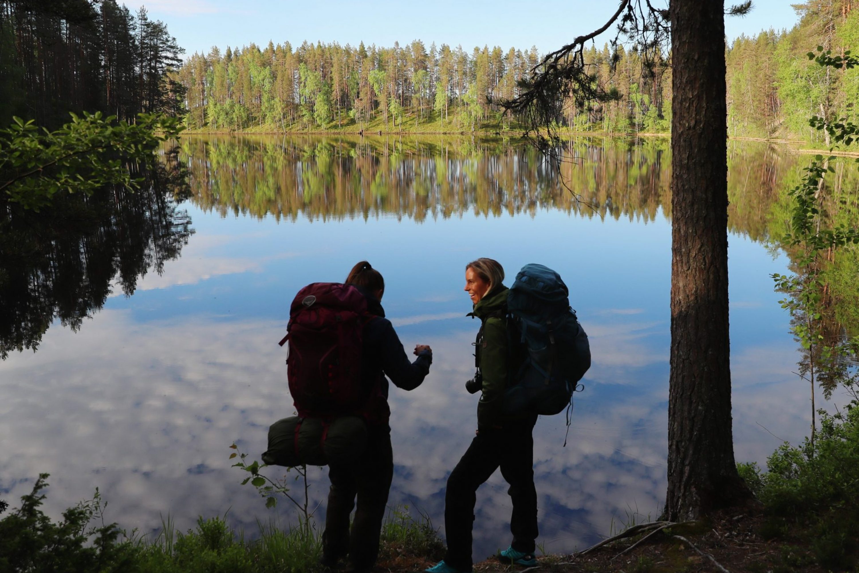 Two hikers by the lake