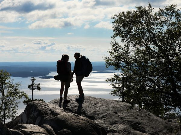 Two silhouettes of hikers on the Koli Hills