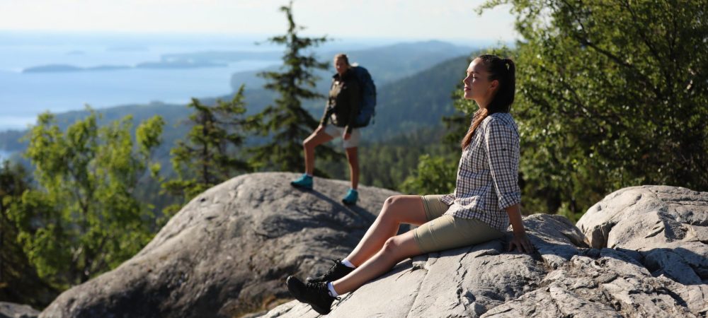 Hikers relaxing and enjoying sunshine at Koli