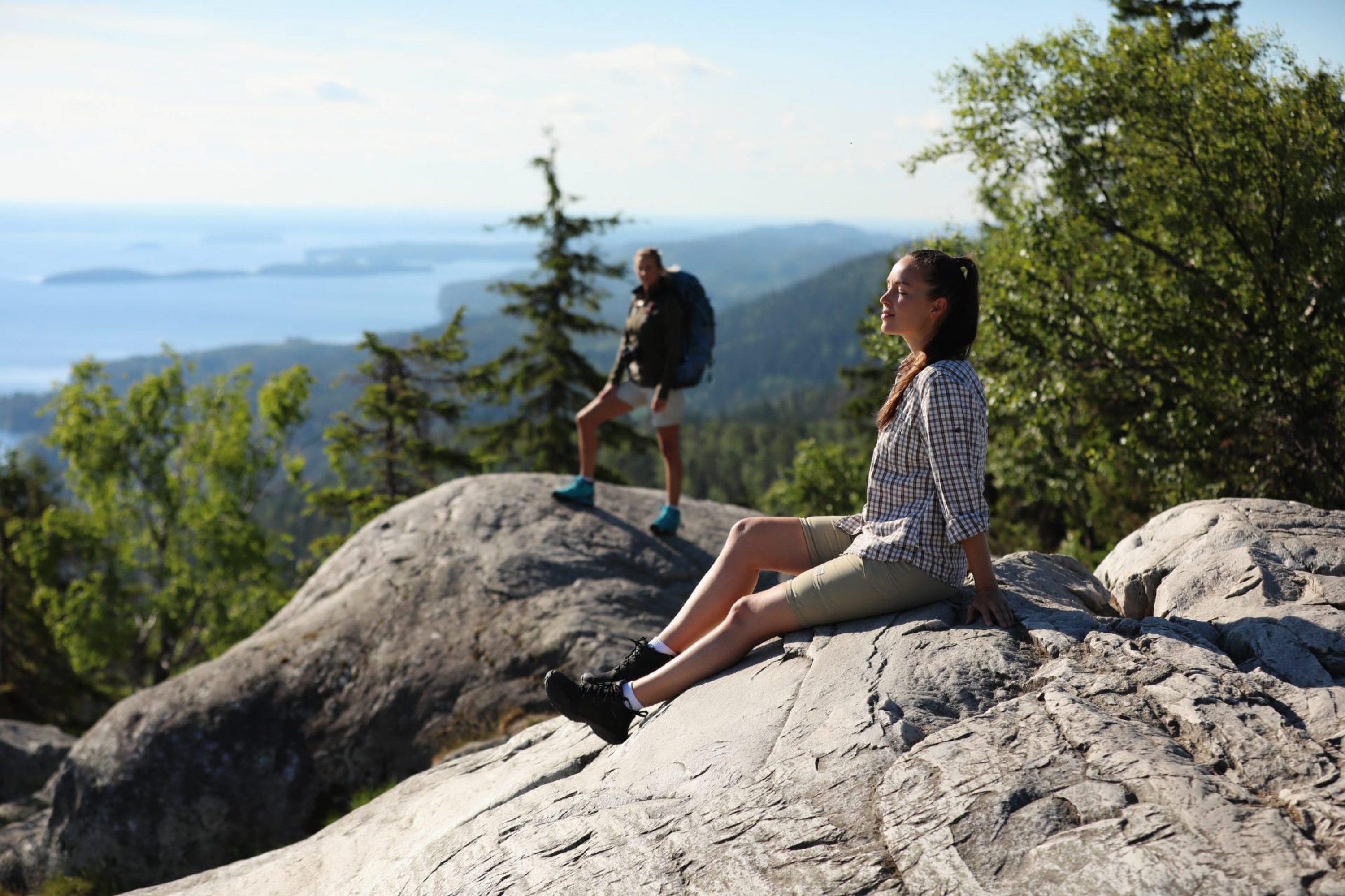 Hikers relaxing and enjoying sunshine at Koli