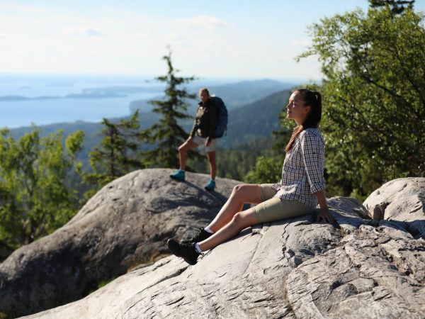 Hikers relaxing and enjoying sunshine at Koli