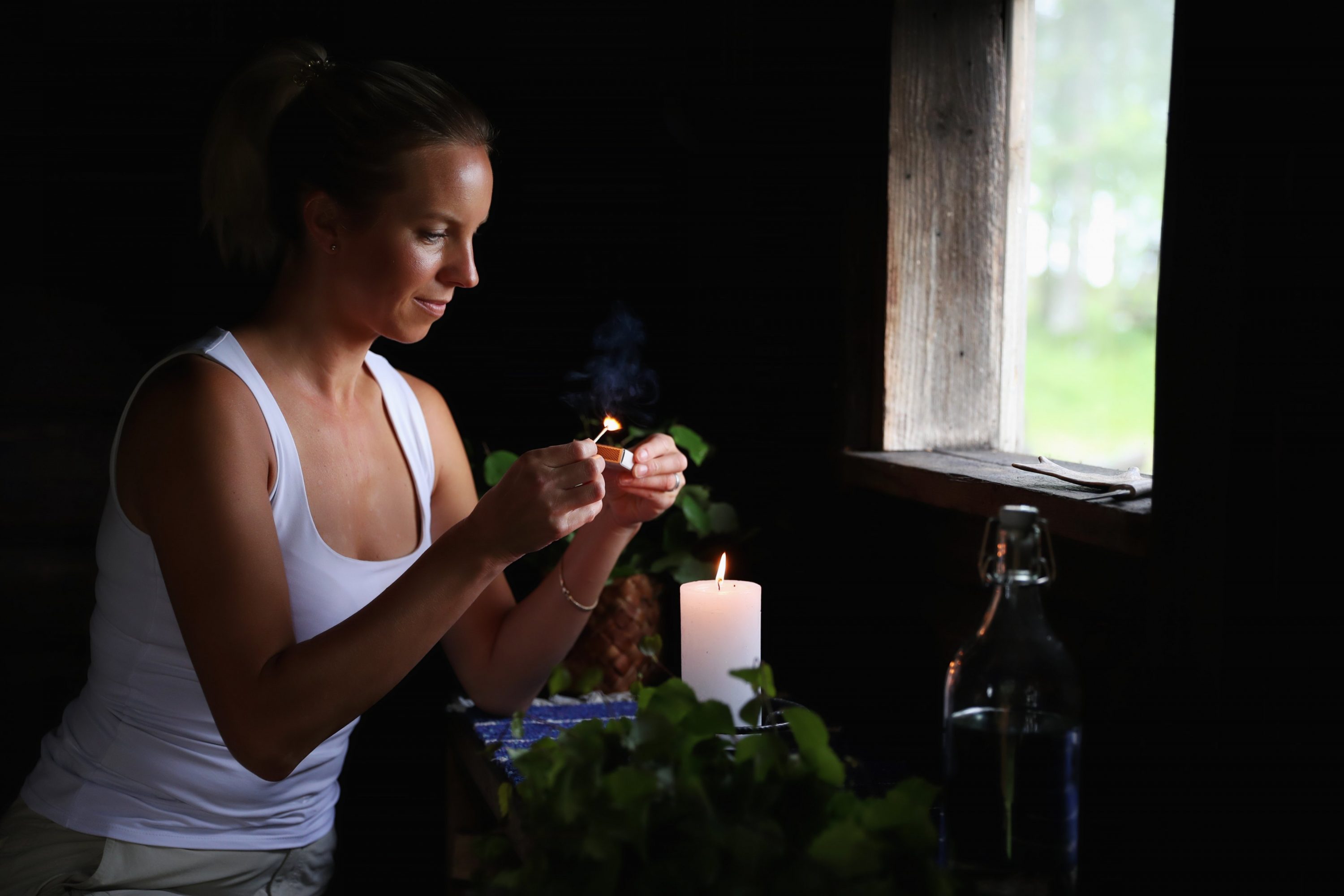 A woman lighting a candle