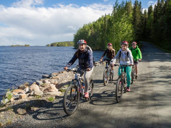 A happy group of bikers by the lake