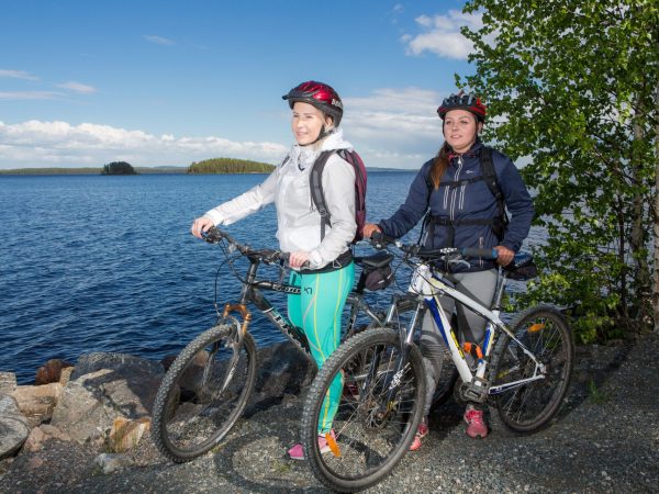 Two bikers by the lake