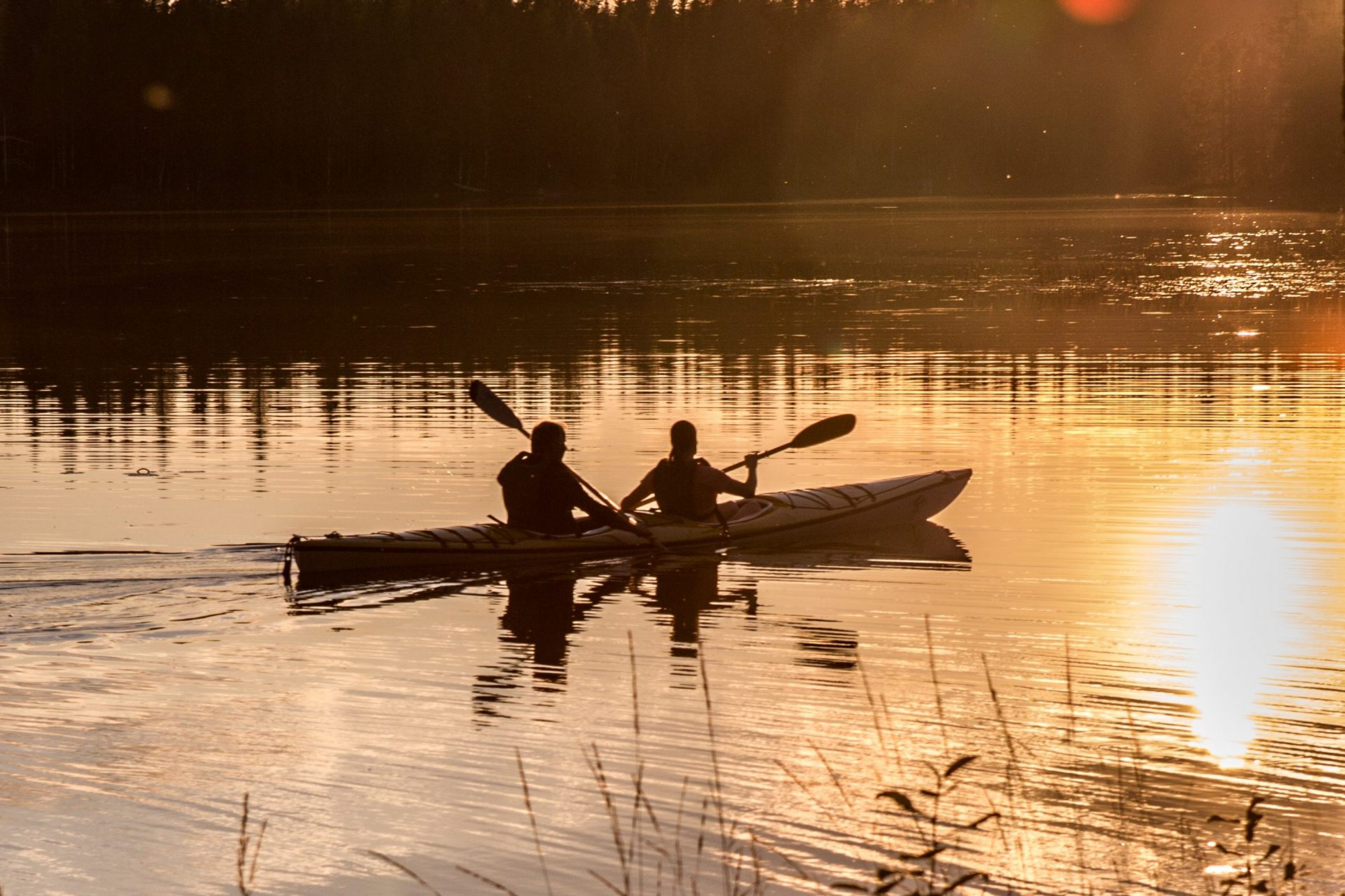 A couple paddling during the sunset